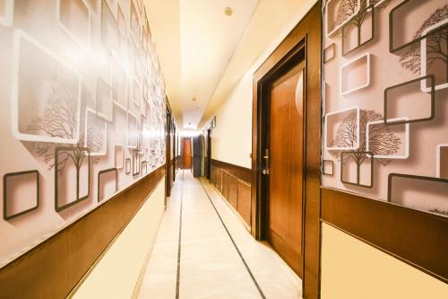 a corridor of a hospital with art on the walls at FabHotel Grand Boutique in New Delhi