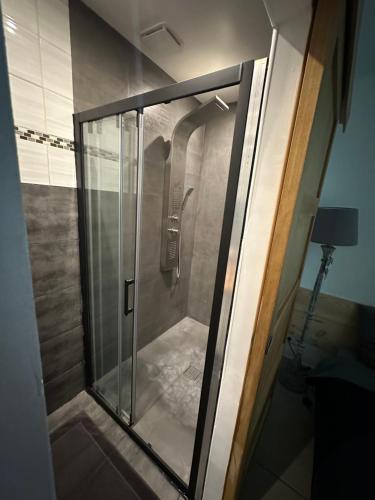 um chuveiro com uma porta de vidro na casa de banho em Maison du pêcheur em Marselha