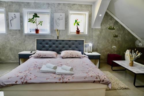 a bedroom with a bed with two towels on it at Cazare MOLDI - regim hotelier in Câmpulung Moldovenesc