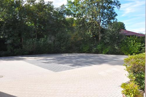 an empty parking lot with trees in the background at Hotel Bavaria Oldenburg in Oldenburg