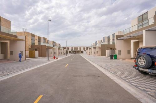 een lege straat met een auto in het midden bij Zapbed Villa C62-03 in Dubai