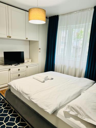 En eller flere senge i et værelse på Blue Apartment