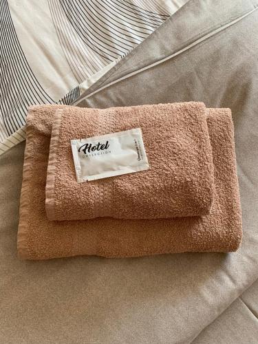 a brown towel sitting on top of a bed at Yurus Hostel in Lviv