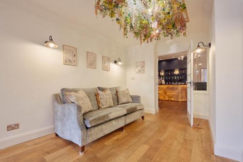 a living room with a couch and a chandelier at Wilding Hotel in Brough