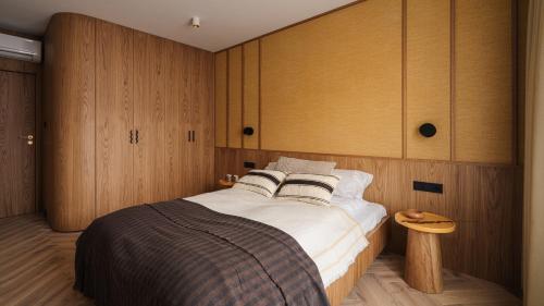 a bedroom with a large bed and wooden cabinets at Apartamenty Sun & Snow Kossak Residence in Krakow