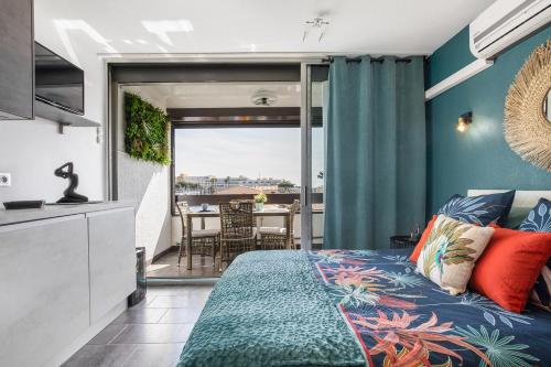 a bedroom with a bed and a balcony at Cap Venus naturiste in Cap d'Agde