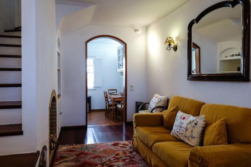 a living room with a couch and a mirror at The Yellow House in Tavira