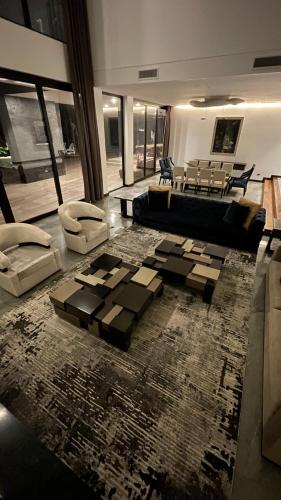 a living room with a couch and a rug at Casa H Luxury Mansion in Estancia Cedrito