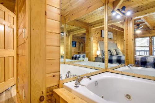 a bathroom with a tub and two mirrors at Pigeon Forge Vacation Rental with Private Hot Tub! in Pigeon Forge