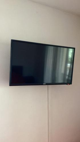 a flat screen tv hanging on a wall at Apartments Arina in Krasici