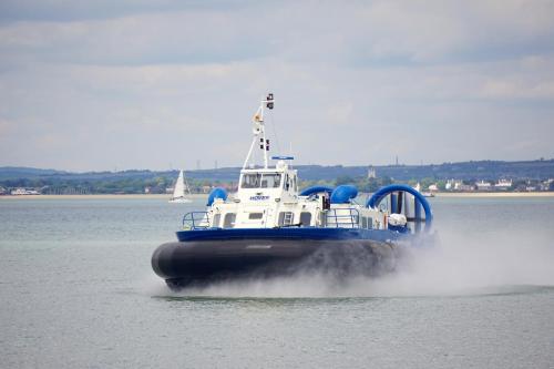 a blue and white boat in the water at The Wight House B&B in Ryde