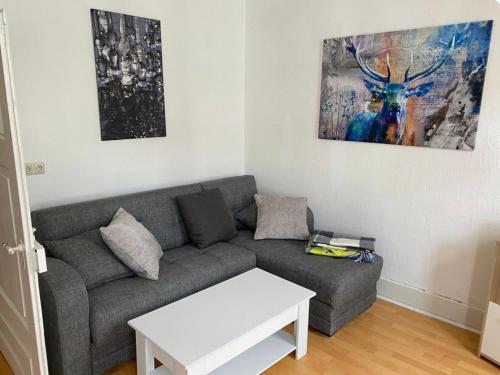 a living room with a couch and a table at Innenstadt Perle in Celle