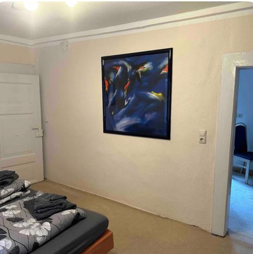 a bedroom with a painting hanging on the wall at Innenstadt Perle in Celle