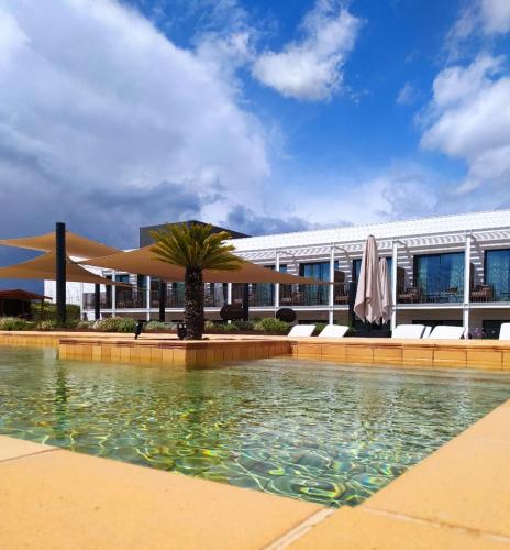 a swimming pool in front of a building at Silken Platja d'Aro in Platja  d'Aro