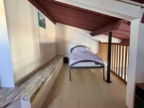 une chambre avec un banc sur un balcon dans l'établissement Appartement Mezzanine 2 pièces - 400m Plage - Clim - Piscines - 6 Pers - FR-1-225-743, à Argelès-sur-Mer