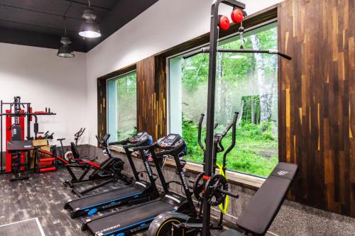 a gym with three treadmills and a row of bikes at NORDHOUSE I in Jastrzębia Góra