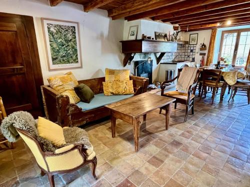 a living room with a couch and a table at Maison Du Lavoir, Venosc - Les 2 Alpes in Vénosc