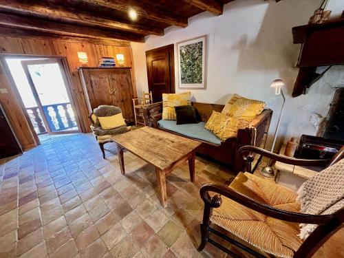 a living room with a couch and a table at Maison Du Lavoir, Venosc - Les 2 Alpes in Vénosc