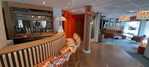 a bar in a restaurant with chairs and a counter at Hôtel AKENA Biarritz - Grande plage in Biarritz