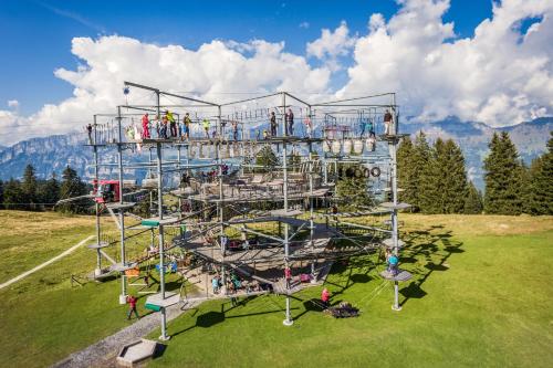 a large playground with people on it in a field at Garni Hotel Torkelbündte in Bad Ragaz