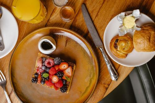 a plate of food with fruit on a table at Sheraton Grand London Park Lane in London