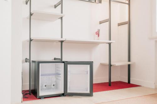 a refrigerator in a room with shelves at M14 SkyView City Center in Padova