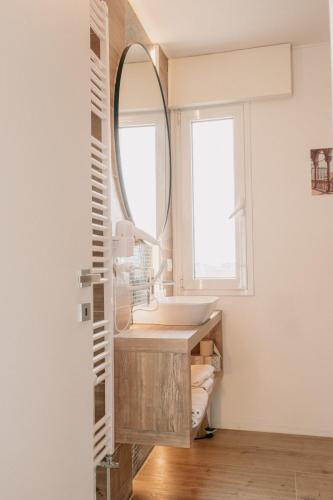 a bathroom with a sink and a mirror at M14 SkyView City Center in Padova