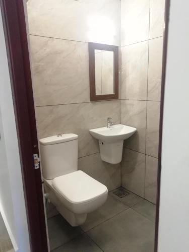 a bathroom with a toilet and a sink at PAUL RESIDENCY in Nedumbassery