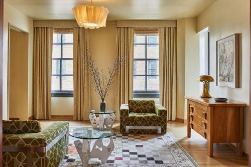 a living room with two chairs and a table at Downtown Los Angeles Proper Hotel, a Member of Design Hotels in Los Angeles