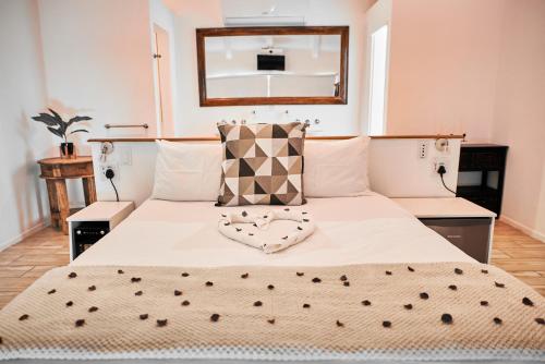 a bedroom with a large bed with a mirror on the wall at theLAB Robertson in Robertson