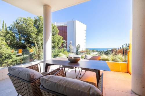 a table and chairs on a balcony with a view at Leiro Residences - Preferred Hotels & Resorts in Fuengirola