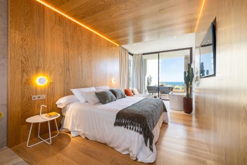 a bedroom with a large bed and a large window at Leiro Residences - Preferred Hotels & Resorts in Fuengirola