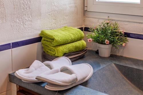 a pair of white slippers sitting on a floor next to a window at Son Bou by the Sea in Alaior