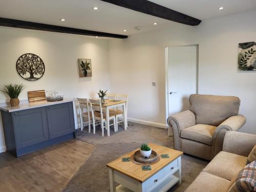 a living room with a couch and a table at Hampstall Inn in Stourport
