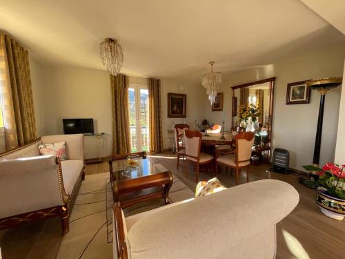 a living room with a couch and chairs and a table at Samorinha House in Assares