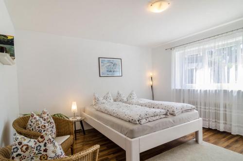 a white room with a bed and a window at Ferienwohnung Rothmund in Überlingen