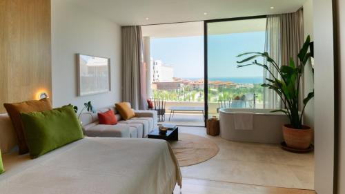 a hotel room with a bed and a bath tub at Leiro Residences in Fuengirola