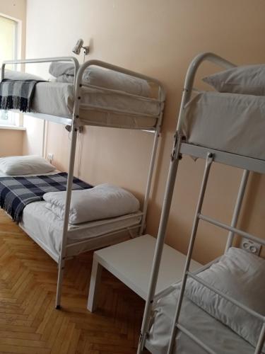 a room with two bunk beds and a stool at Hostel Iskra in Lviv