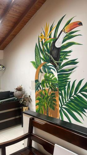 a large painting of a bird on a wall at HOTEL LAS PALMAS in La Virginia