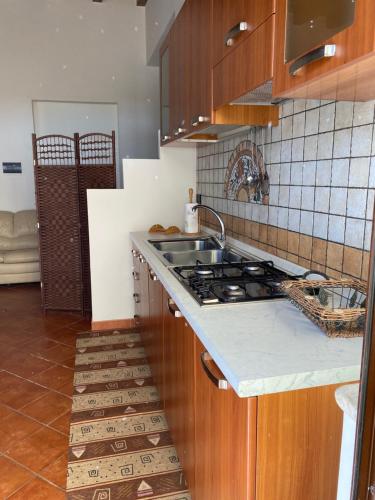 cocina con fregadero y fogones horno superior en Frichi house en Lampedusa