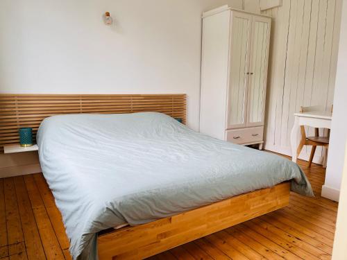 a bed in a bedroom with a wooden floor at Jacqueline in Étretat