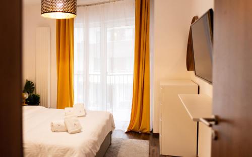 a bedroom with a bed with towels on it at Aria Sophia in Cluj-Napoca