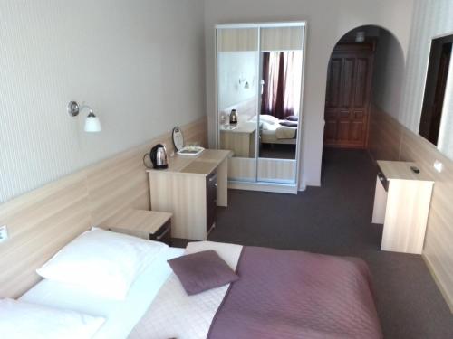 a bedroom with a bed and a large mirror at Hostel Iskra in Lviv