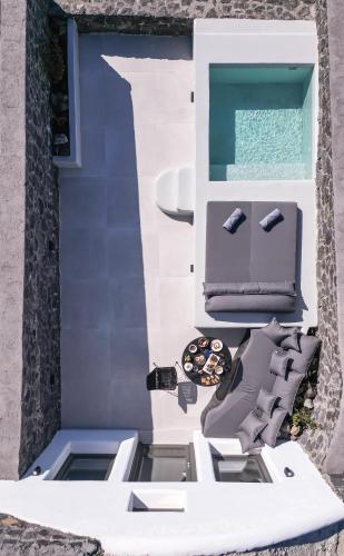 a view of the outside of a house with a boat at Arany Terra in Imerovigli