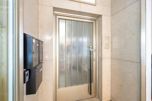 a door in a room with a tv and a door sidx sidx sidx at Top floor apartment next to Marienplatz in Munich