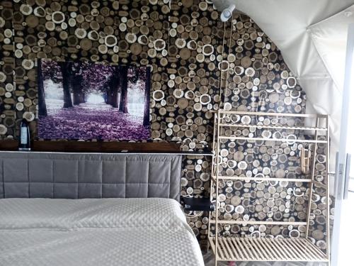 1 dormitorio con 1 cama y una pared con árboles en Podere Kiri Dome Experience, en Decimomannu