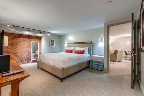 a bedroom with a bed and a brick wall at Nashville Riverfront Lofts in Nashville