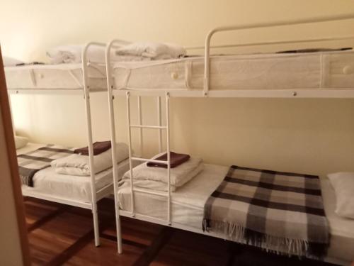 two bunk beds in a room with white walls at Hostel Iskra in Lviv