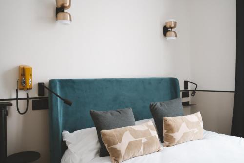 a bedroom with a bed with two pillows at Hôtel des Beaux Arts in Paris