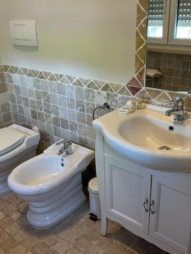 a bathroom with a sink and a toilet at Garda Flow Holiday Home in Lonato del Garda